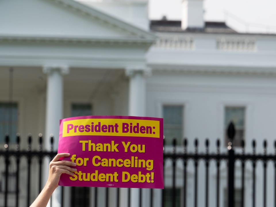 George Washington University student Kai Nilsen and other student loan debt activists rally outside the White House a day after President Biden announced a plan that would cancel $10,000 in student loan debt for those making less than $125,000 a year in Washington, DC, on August 25, 2022.