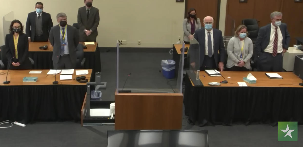 In this image taken from video, the prosecution, left, and the defense, right, stand, as the jury enters the courtroom to deliver a question to Hennepin County Judge Regina Chu, during deliberations Tuesday, Dec. 21, 2021, in former Brooklyn Center police Officer Kim Potter's trial for the April 11 death of Daunte Wright, at the Hennepin County Courthouse in Minneapolis. (Court TV via AP, Pool)