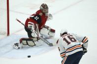 Edmonton Oilers left wing Jujhar Khaira (16) is unable to get to a pass as Arizona Coyotes goaltender Antti Raanta (32) slides over to protect the net during the first period of an NHL hockey game Tuesday, Feb. 4, 2020, in Glendale, Ariz. (AP Photo/Ross D. Franklin)