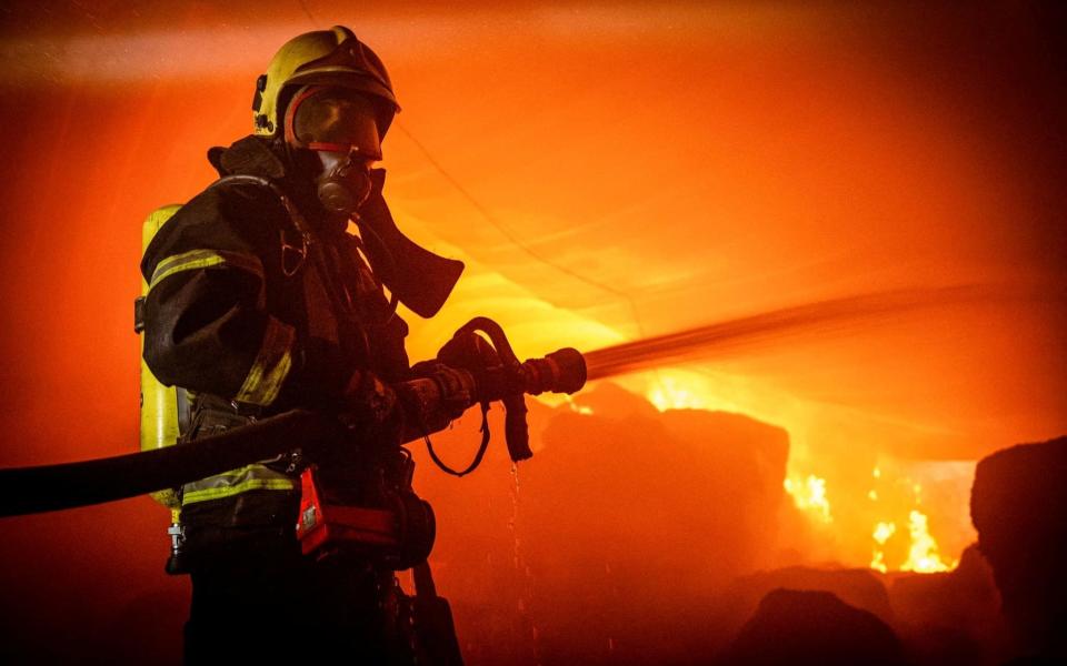 A firefighter works at a site of storage facilities hit during Russian missile and drone strikes in Odesa