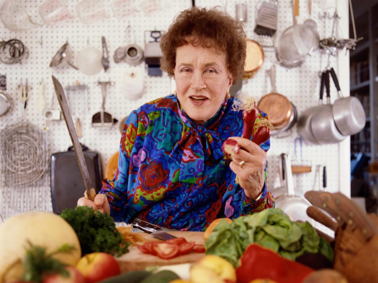 julia child holding up vegetable and knife