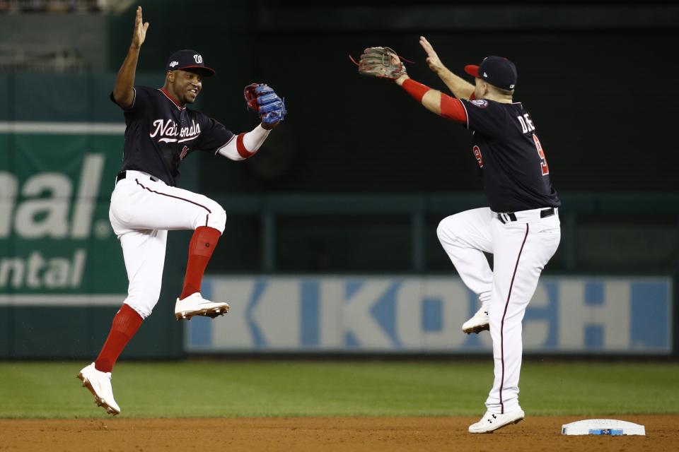 Washington Nationals' Victor Robles and Brian Dozier celebrate after Game 3 of the baseball National League Championship Series against the St. Louis Cardinals Monday, Oct. 14, 2019, in Washington. The Nationals won 8-1 to take a 3-0 lead in the series. (AP Photo/Patrick Semansky)