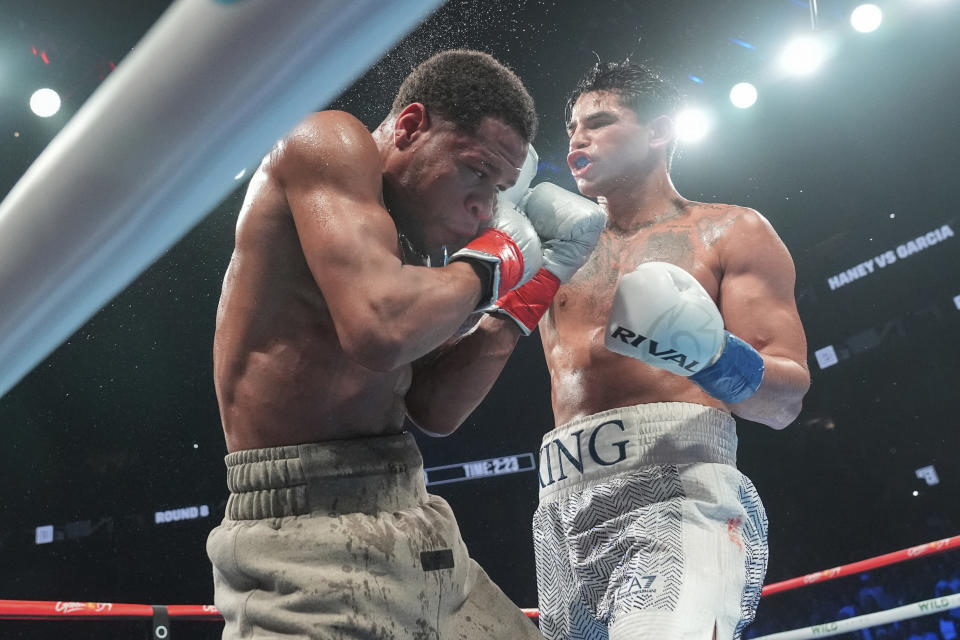 Ryan Garcia, right, punches Devin Haney during the eighth round of a super lightweight boxing match early Sunday, April 21, 2024, in New York. Garcia won the fight. (AP Photo/Frank Franklin II)