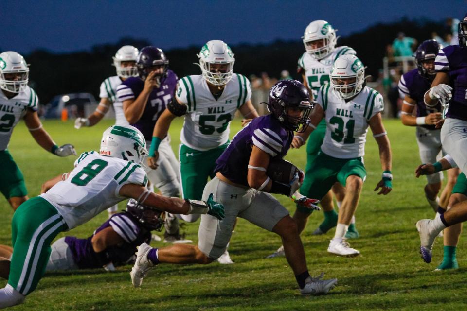 Mason running back Matthew King (11) avoids tackles from Wall defenders on a touchdown run at R. Clinton Schulze Stadium on Sept. 29, 2023