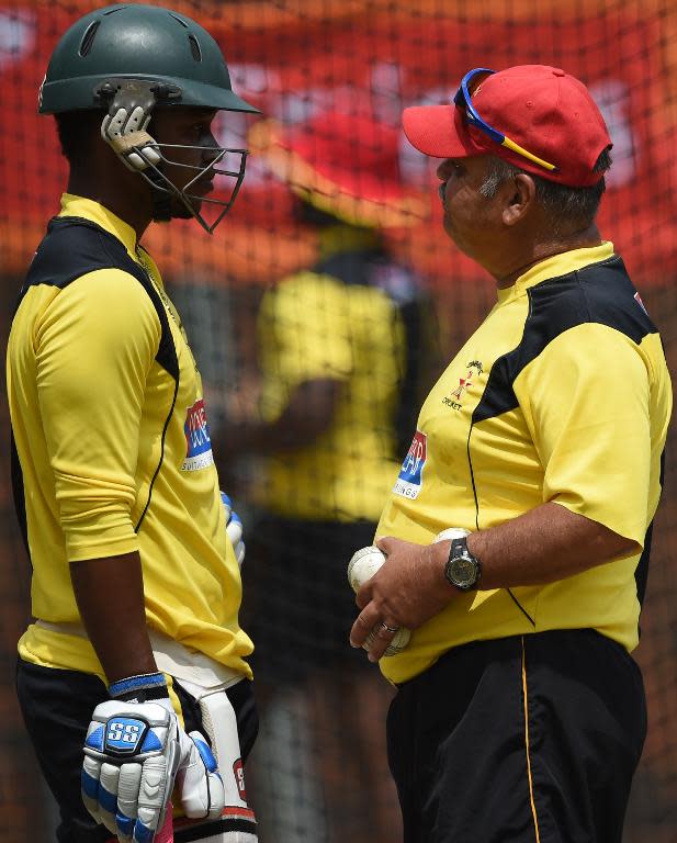 Zimbabwe's Chamu Chibhabha (L) with coach Dave Whatmore during a training session ahead of their World Cup Pool B match against Pakistan on February 28, 2015