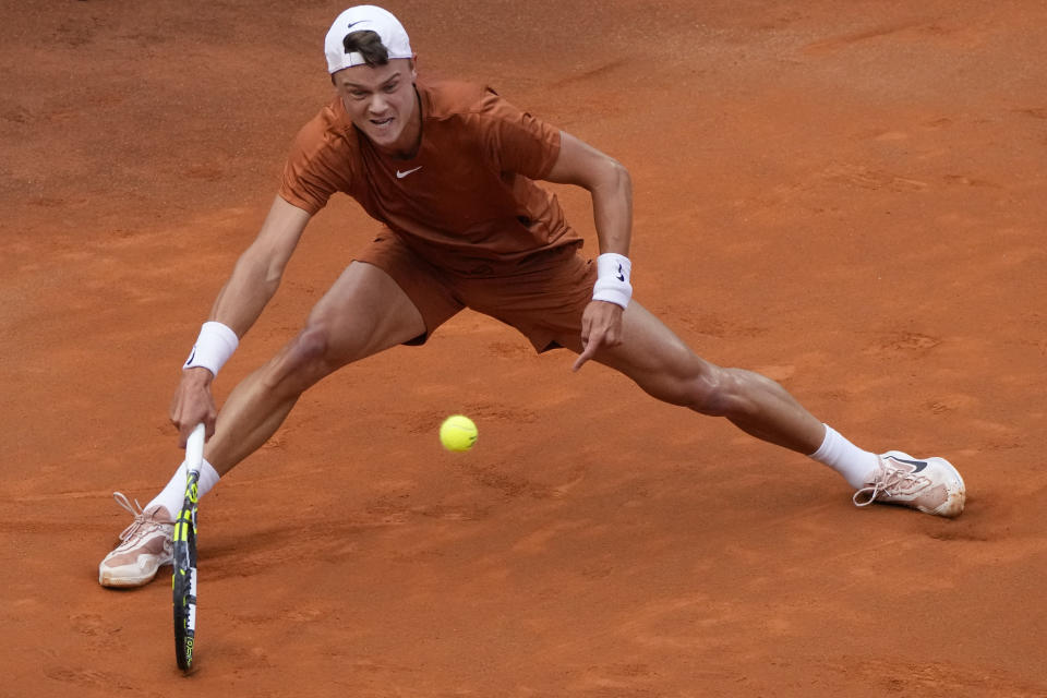 Denmark's Holger Rune returns the ball to Daniil Medvedev of Russia during the men's final tennis match at the Italian Open tennis tournament in Rome, Italy, Sunday, May 21, 2023. (AP Photo/Gregorio Borgia)
