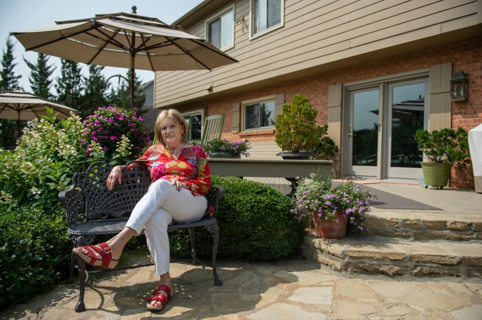 Lana Santavicca poses for a portrait outside her home in the Indian Springs subdivision of Sharonville on Wednesday, Sept. 16, 2020. Santavicca has lived at her Indian Springs home for 14 years but recently decided its time for a new chapter, “I want to try being an urbanite, I like being near the sounds, lights and culture,” she said. 