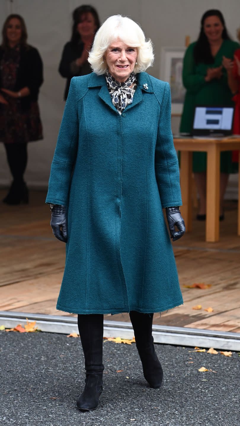 <p>During the Duchess and Prince Charles's visit to Northern Ireland, Camilla met with staff, supporters and service users at the Belfast & Lisburn Women's Aid organization. For this day of appearances, the Duchess chose a teal coat, patterned scarf, and black boots. </p>