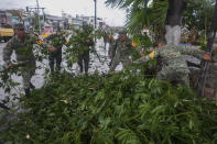 Soldiers collect branches felled by Hurricane Beryl, in Tulum, Mexico, Friday, July 5, 2024. (AP Photo/Fernando Llano)