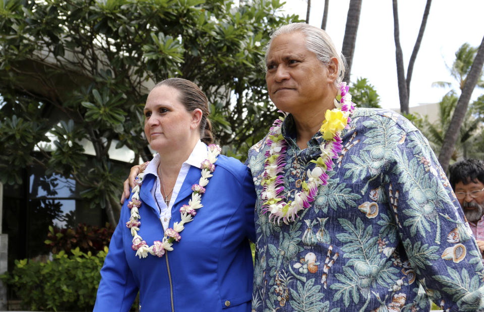 FILE - In this Oct. 20, 2017 file photo former Honolulu Police Chief Louis Kealoha, right, and his wife, Katherine Keahola leave federal court in Honolulu. Opening statements are expected Wednesday, May 22, 2019, after 12 jurors and five alternates are selected for the trial of retired Honolulu police chief Louis Kealoha, his wife and current and former officers. Prosecutors say Kealoha and his former city deputy prosecutor wife, Katherine Kealoha, abused their power to frame a relative for stealing their home mailbox because he threatened to expose financial fraud that funded the couple's lavish lifestyle. (AP Photo/Caleb Jones, File)