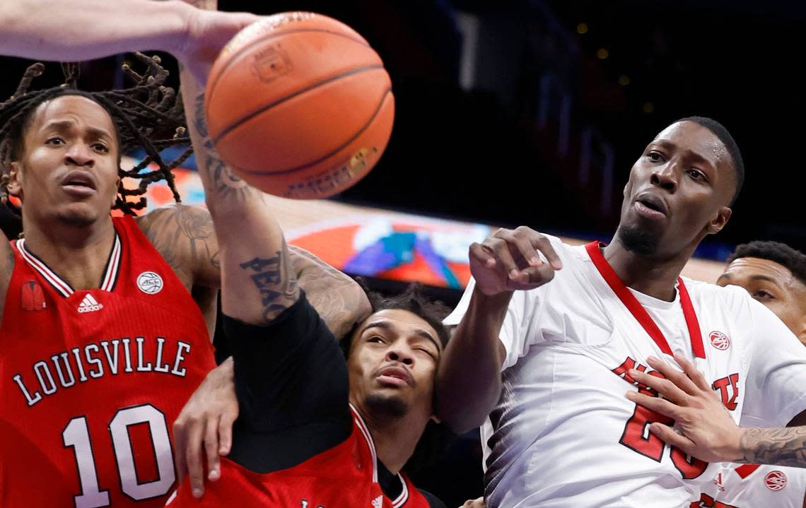 Louisville’s Kaleb Glenn (10), Skyy Clark (55) and N.C. State’s Mohamed Diarra (23) go after the loose ball during the first half of N.C. State’s game against Louisville in the first round of the 2024 ACC Men’s Basketball Tournament at Capital One Arena in Washington, D.C., Tuesday, March 12, 2024.