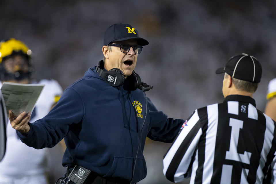 UNIVERSITY PARK, PA - OCTOBER 19:  Head coach Jim Harbaugh of the Michigan Wolverines discusses a previous play with a line judge during the fourth quarter against the Penn State Nittany Lions on October 19, 2019 at Beaver Stadium in University Park, Pennsylvania. Penn State defeats Michigan 28-21.  (Photo by Brett Carlsen/Getty Images)