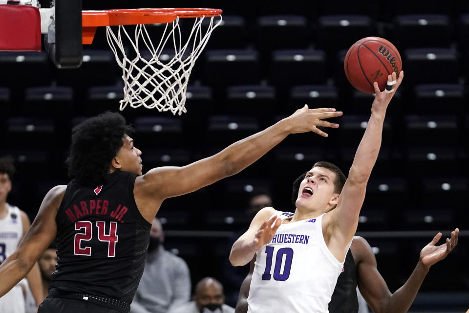 Northwestern forward Miller Kopp, right, shoots against Rutgers guard/forward Ron Harper Jr., during the second half of an NCAA college basketball game in Evanston, Ill., Sunday, Jan. 31, 2021. (AP Photo/Nam Y. Huh)