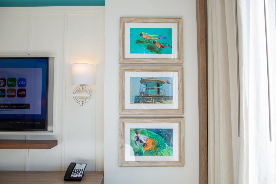 three panels of wall art with beach and tropical themes