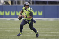 FILE - In this Oct. 11, 2020, file photo, Seattle Seahawks quarterback Russell Wilson looks for a receiver during the first half of the team's NFL football game against the Minnesota Vikings in Seattle. Wilson and his Grammy-winning wife, pop singer Ciara, are putting their money and celebrity behind rebranding a charter school, which advocates hope will boost the troubled Washington state charter school sector that has suffered from enrollment problems after years of legal challenges. (AP Photo/Ted S. Warren, File)