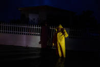 <p>A man wearing a rain cover stands in the darkness in front of a house after Hurricane Fiona made landfall in Guayanilla, Puerto Rico September 18, 2022. REUTERS/Ricardo Arduengo</p> 