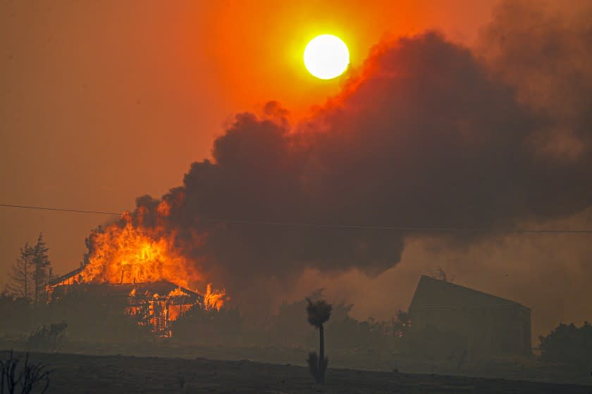 A house on Cima Mesa Road in Juniper Hills burns as the Bobcat fire continues to rage Friday.