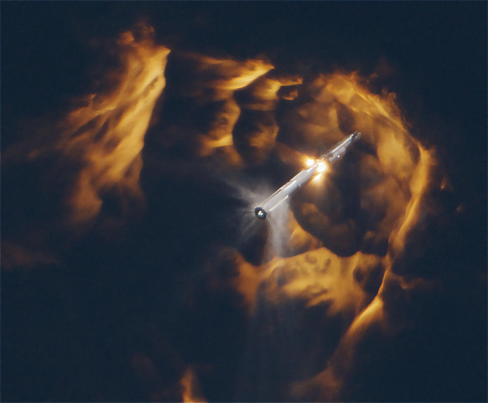 A giant rocket separating during stage separation, with fiery plumes in all directions.