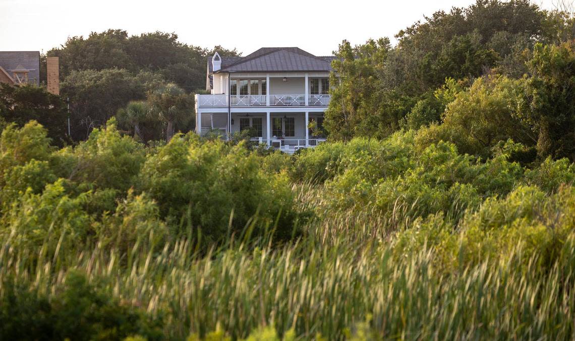A house peaks through the trees of a maritime forest along the Sullivan’s Island shoreline. Shifting sands are having opposite effects on some Charleston area beaches with erosion claiming the Folly Beach shoreline while Sullivan Island’s beach is growing. July 21, 2022.