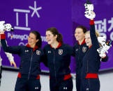 <p>American speed skaters Brittany Bowe, Carlijn Schoutens, Heather Bergsma, and Mia Manganello take the podium after winning bronze in the ladies' team pursuit event. </p>