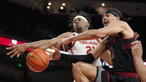 Stanford forward Jaiden Delaire, right, tries to shoot as Southern California guard Reese Dixon-Waters knocks the ball from his hands during the first half of an NCAA college basketball game Thursday, Jan. 27, 2022, in Los Angeles. (AP Photo/Mark J. Terrill)
