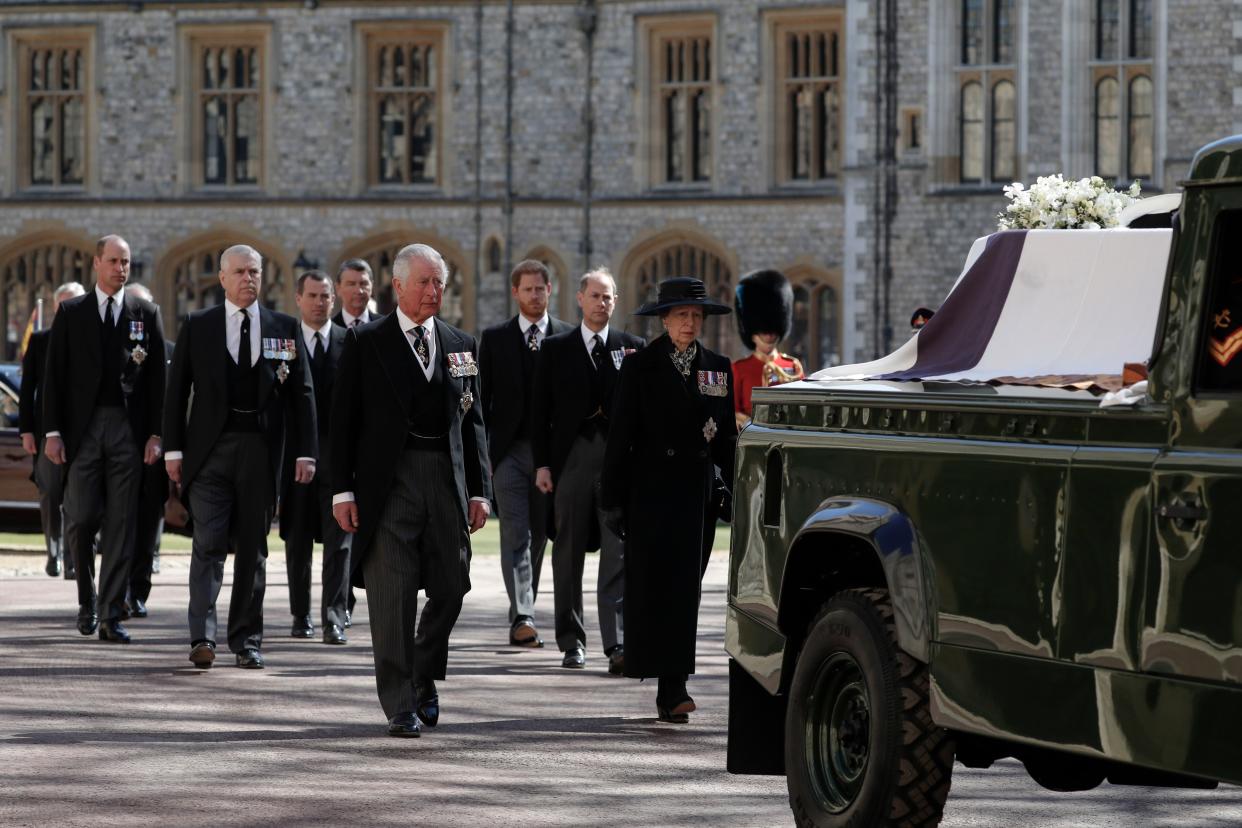 Britain's Prince Charles, left, Princess Anne, Prince Andrew. Prince Edward, Prince William, Peter Phillips, Prince Harry, Earl of Snowdon and Tim Laurence follow the coffin in a ceremonial procession for the funeral of Britain's Prince Philip inside Windsor Castle in Windsor, England Saturday April 17, 2021.