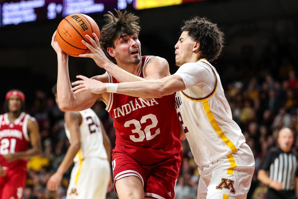 Mar 6, 2024; Minneapolis, Minnesota, USA; Indiana Hoosiers guard Trey Galloway (32) works around Minnesota Golden Gophers guard Mike Mitchell Jr. (2) during the second half at Williams Arena.