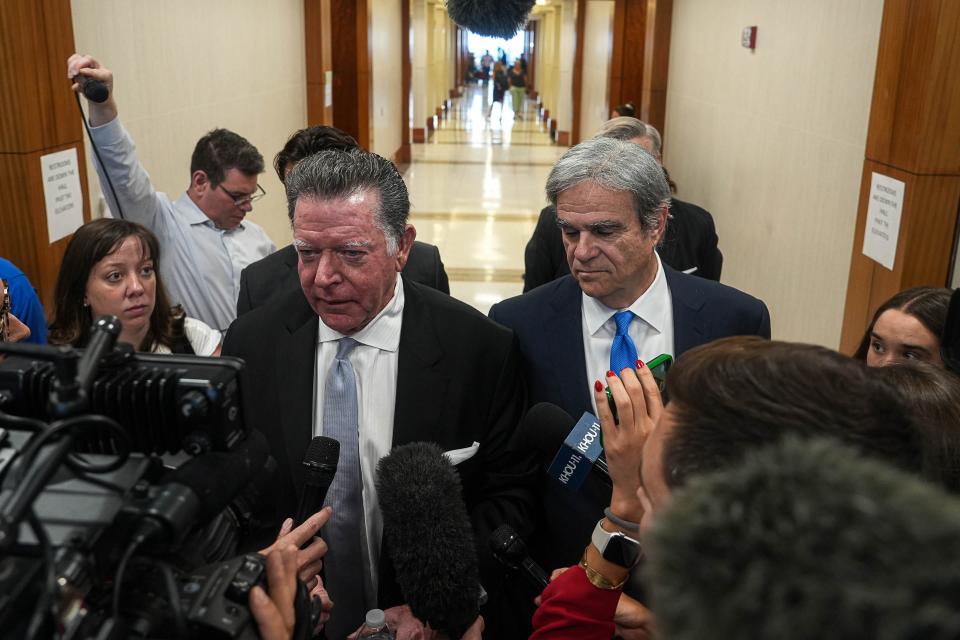 Dan Cogdell, left, and Philip Hilder, right, defense attorneys in the 8-year-old securities fraud case against Texas Attorney General Ken Paxton, speak to media outside the courtroom after a hearing at Harris County Criminal Justice Center on Thursday, Aug. 3, 2023 in Houston, Texas.