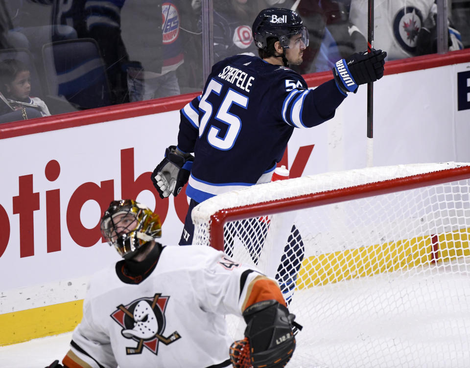 Winnipeg Jets' Mark Scheifele (55) celebrates his goal on Anaheim Ducks goaltender Anthony Stolarz (41) during the third period of an NHL Hockey game in Winnipeg, Manitoba on Sunday, Dec. 4, 2022. (Fred Greenslade/The Canadian Press via AP)