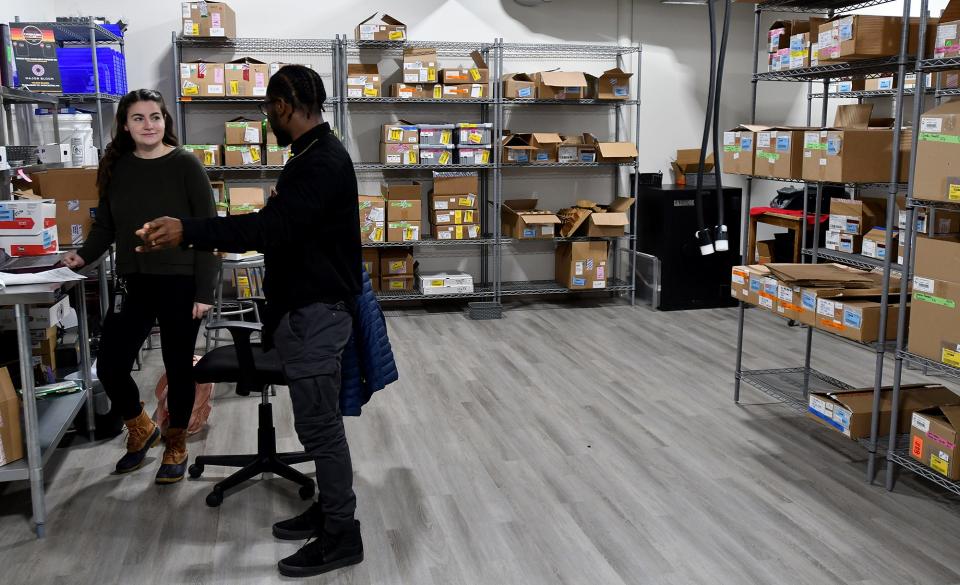 Major Bloom owner Ulysses Youngblood talks with Jill Skulsky, director of business development, in the inventory room.