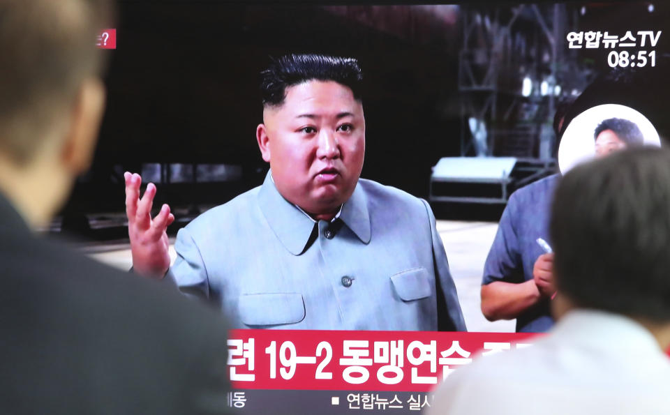 People watch a TV showing a file image of North Korean leader Kim Jong Un during a news program at the Seoul Railway Station in Seoul, South Korea, Thursday, July 25, 2019. North Korea fired two unidentified projectiles into the sea on Thursday, South Korea's military said, the first launches in more than two months as North Korean and U.S. officials struggle to restart nuclear diplomacy. (AP Photo/Ahn Young-joon)