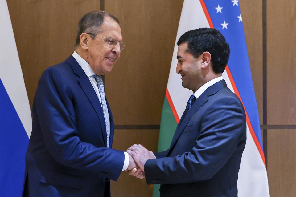 In this handout photo released by Russian Foreign Ministry Press Service, Russian Foreign Minister Sergey Lavrov, left, and Uzbekistan's Acting Foreign Minister Bakhtiyor Saidov greet each other prior to the talks on the sideline of a ministerial meeting in Samarkand, Uzbekistan, Thursday, April 13, 2023. (Russian Foreign Ministry Press Service via AP)