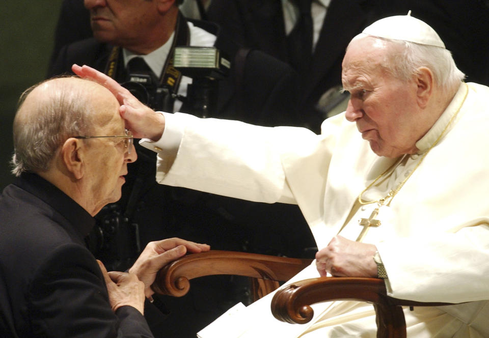 FILE - Pope John Paul II gives his blessing to late Rev. Marcial Maciel, founder of Legionaries of Christ, during a special audience the pontiff granted to about four thousand participants of the Regnum Christi movement, at the Vatican, Nov. 30, 2004. Benedict reversed his beloved predecessor by taking action against the 20th century’s most notorious pedophile priest, the Rev. Marcial Maciel. Benedict took over Maciel’s Legionaries of Christ, a conservative religious order held up as a model of orthodoxy by John Paul, after it was revealed that Maciel sexually abused seminarians and fathered at least three children. The Vatican announced Saturday Dec. 31, 2022 that Benedict, the former Joseph Ratzinger, had died at age 95. (AP Photo/Plinio Lepri, File)