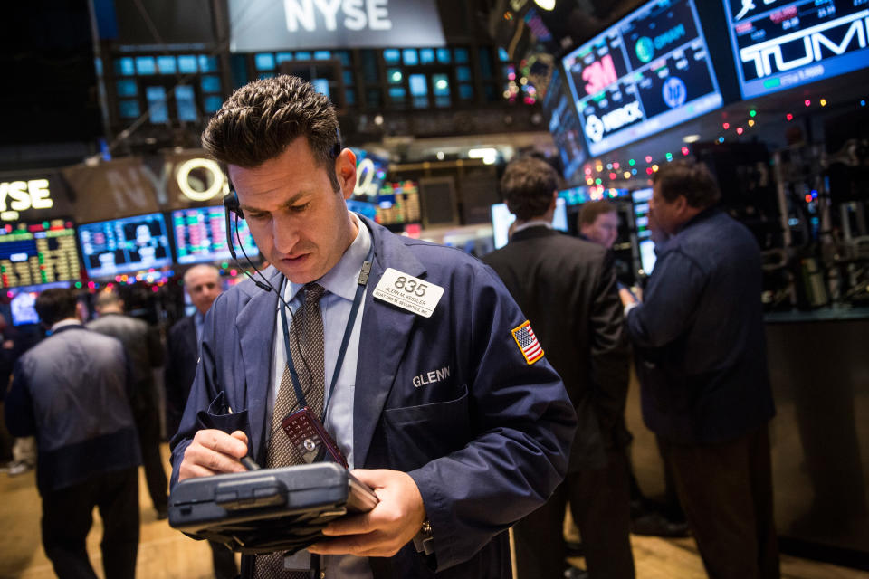 NEW YORK, NY - DECEMBER 24:  Traders work on the floor of the New York Stock Exchange on the morning of December 24, 2014 in New York City. The market opened above 18,000 points for the first time in its history this morning.  (Photo by Andrew Burton/Getty Images)