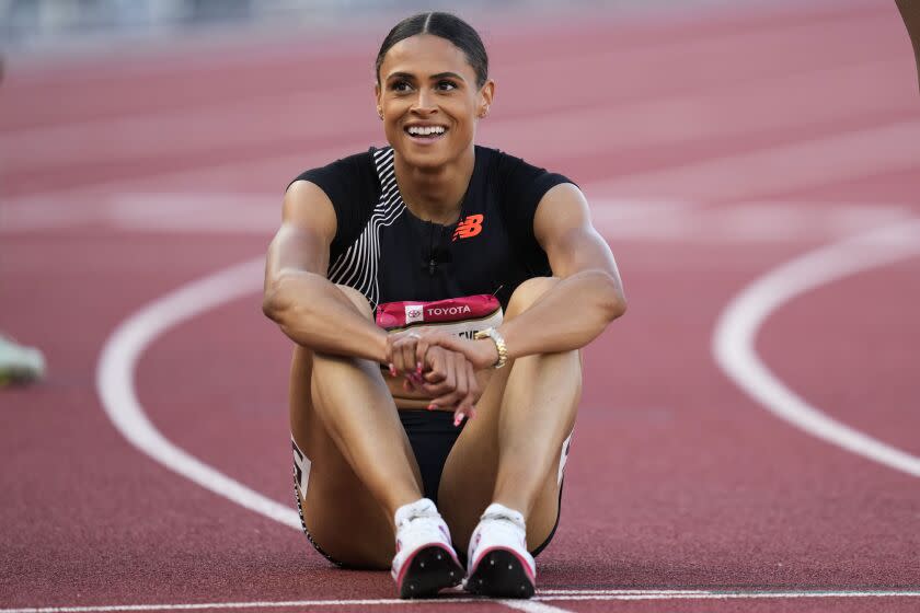 Sydney McLaughlin-Levrone smiles as she catches her breath after winning the women's 400 meter final