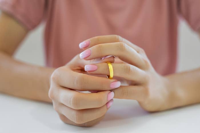 A woman removing her wedding band