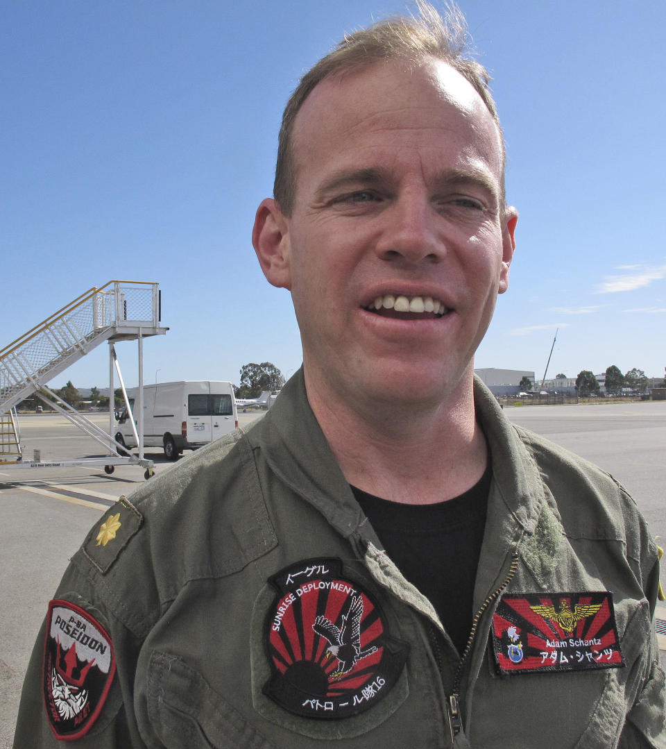 In this April 8, 2014 photo, U.S. Lt. Cmdr. Adam Schantz speaks during an interview about the U.S. Navy's P-8 Poseidon role in the ongoing search operations for the missing Malaysia Airlines Flight 370 in Perth, Australia. Schantz is the officer in charge of the 32 air and ground crew manning the surveillance aircraft, which are modified Boeing 737s. (AP Photo/Nick Perry)