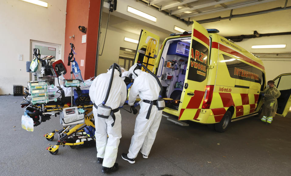 A patient with COVID-19 disease gets prepared to be transferred from Thueringen Kliniken hospital to a hospital in Hanover by an emergency intensive care mobile in Saalfeld, Germany, Friday, Nov. 26, 2021. (Bodo Schackow/dpa via AP)