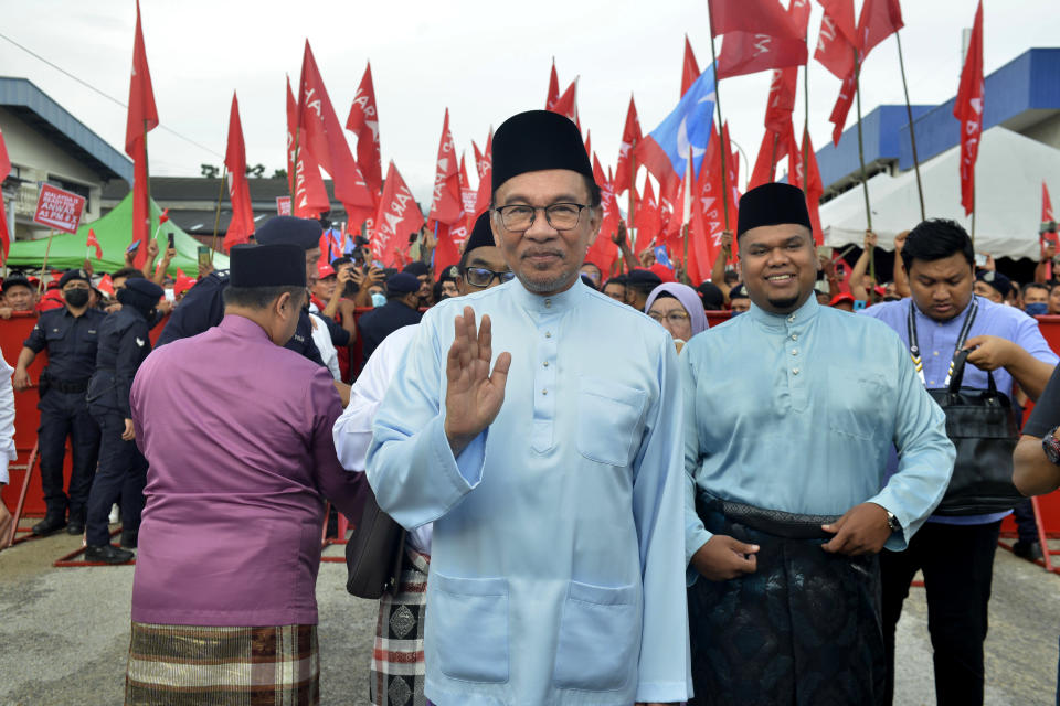 Malaysian opposition leader Anwar Ibrahim waves to photographers after submitting his nomination papers at a nomination center in Tambun, Malaysia on Nov. 5, 2022. With a battle cry of “We Can,” reformist opposition leader Anwar Ibrahim has launched what could be his last chance to fulfill a 2-decade-long quest to become Malaysia’s leader in Nov. 19, 2022, general elections. (AP Photo/JohnShen Lee)