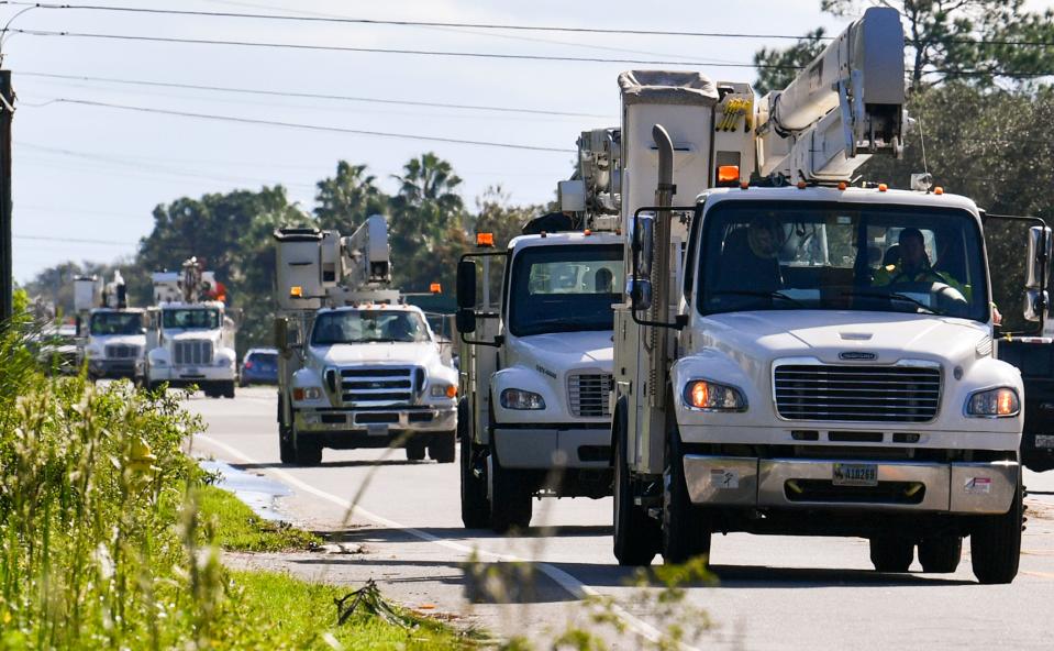 Power company trucks head for the interstate after leaving the staging area at American Muscle Car Museum in Melbourne. Craig Bailey/FLORIDA TODAY via USA TODAY NETWORK