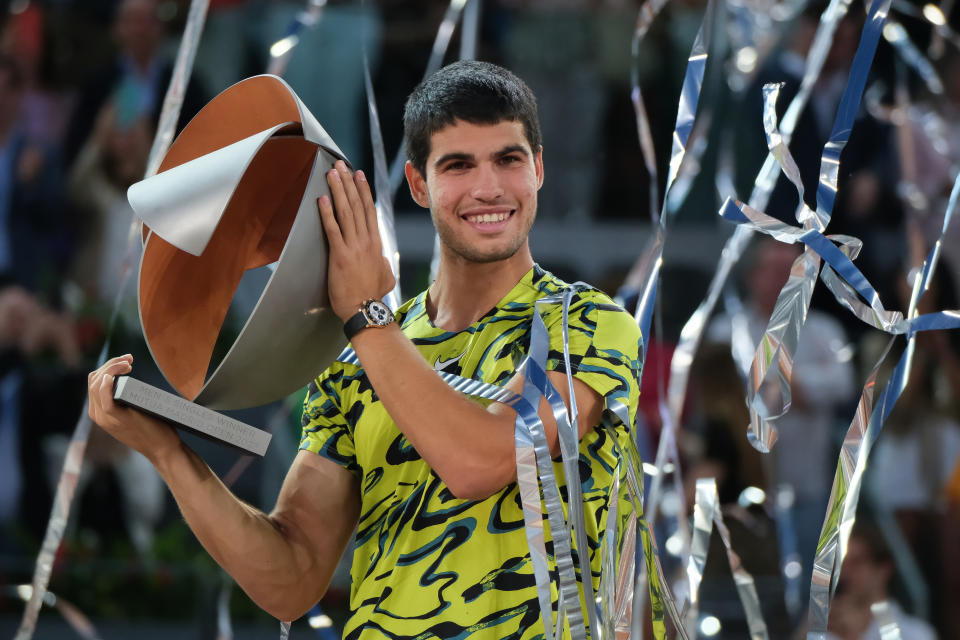 Carlos Alcaraz celebrates with the Madrid Open title.