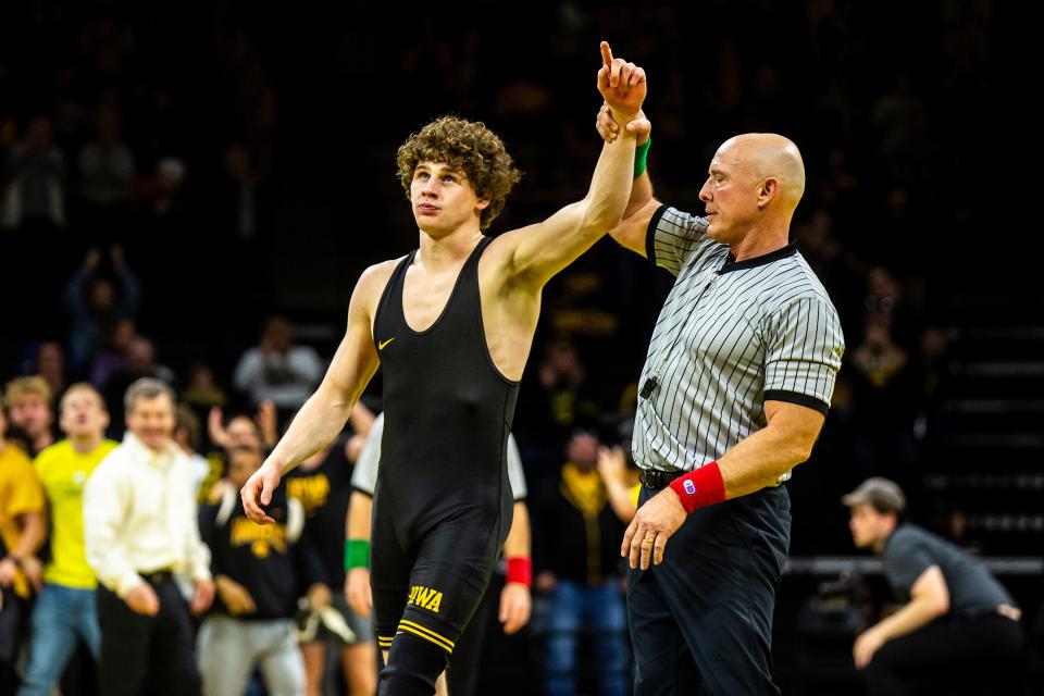 Iowa's Cobe Siebrecht has his hand raised after scoring a fall at 157 pounds during a NCAA men's wrestling dual against Penn, Saturday, Nov. 26, 2022, at Carver-Hawkeye Arena in Iowa City, Iowa.
