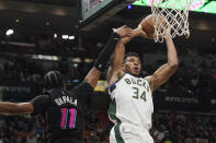 Milwaukee Bucks forward Giannis Antetokounmpo (34) drives to the basket as Miami Heat forward KZ Okpala (11) defends during the second half of an NBA basketball game, Wednesday, Dec. 8, 2021, in Miami. The Heat defeated the Bucks 113-104. (AP Photo/Marta Lavandier)