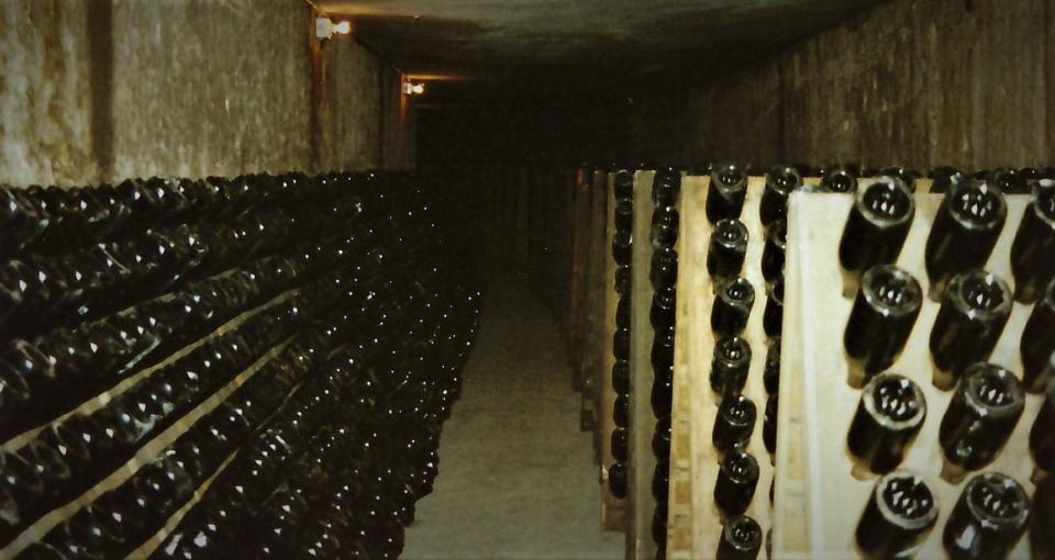 During riddling, bottles are then placed on special racks in caves. The bottles are turned a quarter turn about four times a day – some by hand, some mechanically. This shakes the dead yeast cells into the neck of the bottle.