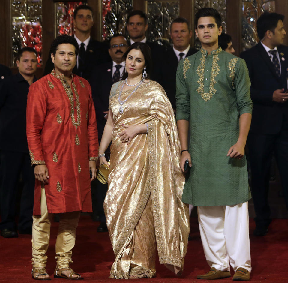 Formet Indian cricketer Sachin Tendulkar, left, his wife Anjali and son Arjun arrive to attend the wedding of Isha Ambani, the daughter of Reliance Industries Chairman Mukesh Ambani, and Anand Piramal in Mumbai, India, Wednesday, Dec. 12, 2018. In a season of big Indian weddings, the Wednesday marriage of the scions of two billionaire families might be the biggest of them all. Isha is the Ivy League-educated daughter of industrialist Mukesh Ambani, thought to be India's richest man. The groom is the son of industrialist Ajay Piramal, thought to be worth $10 billion. (AP Photo/Rajanish Kakade)