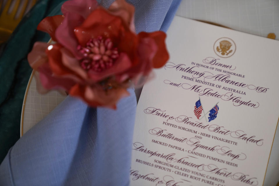 A menu is placed on a table setting for the State Dinner on Wednesday with Australia's Prime Minister Anthony Albanese is seen in the State Dining Room during a media preview Tuesday, Oct. 24, 2023, at the White House in Washington. (AP Photo/Mark Schiefelbein)