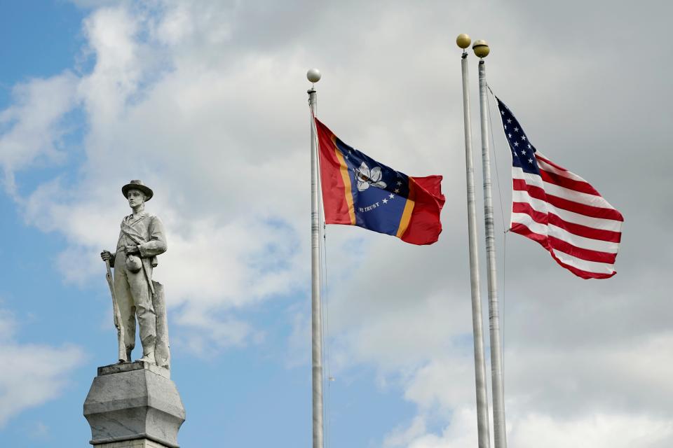 The Mississippi state and U.S. flags fly near the Rankin County Confederate Monument in the downtown square of Brandon on March 3, 2023.