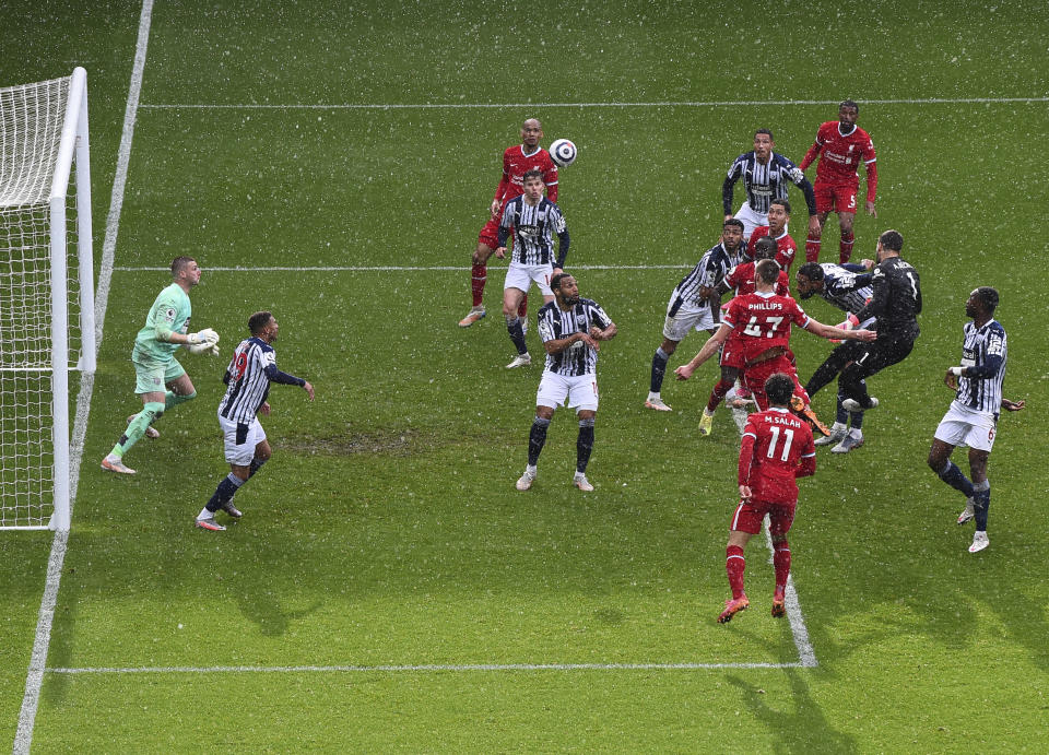 Liverpool's goalkeeper Alisson, second right, scores his side's second goal during the English Premier League soccer match between West Bromwich Albion and Liverpool at the Hawthorns stadium in West Bromwich, England, Sunday, May 16, 2021. (Laurence Griffiths/Pool via AP)