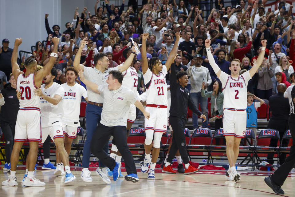 Loyola Marymount players celebrate a 78-74 overtime victory over Saint Mary's in an NCAA college basketball game Thursday, Feb. 9, 2023, in Los Angeles. (AP Photo/Ringo H.W. Chiu)