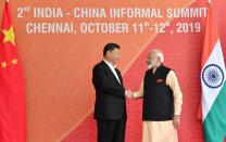 In this handout photo provided by the Indian Prime Minister's Office, Chinese President Xi Jinping and Indian Prime Minister Narendra Modi shake hands in Mamallapuram, India. Xi met with Modi at a time of tensions over Beijing's support for Pakistan in opposing India's downgrading of Kashmir's semi-autonomy and continuing restrictions on the disputed region. (Indian Prime Minister's Office via AP)